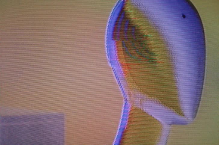 Digital image showing box and humanoid head suffers from static and signal noise