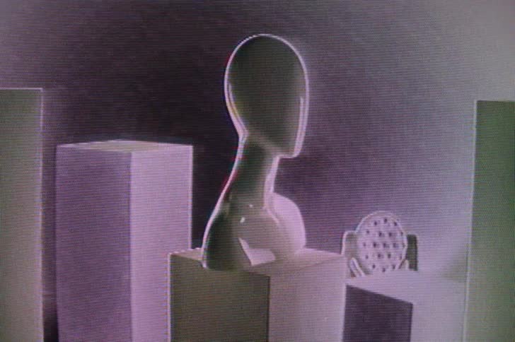 A mannequin bust on a pedestal flashes in and out of sight as the image distorts