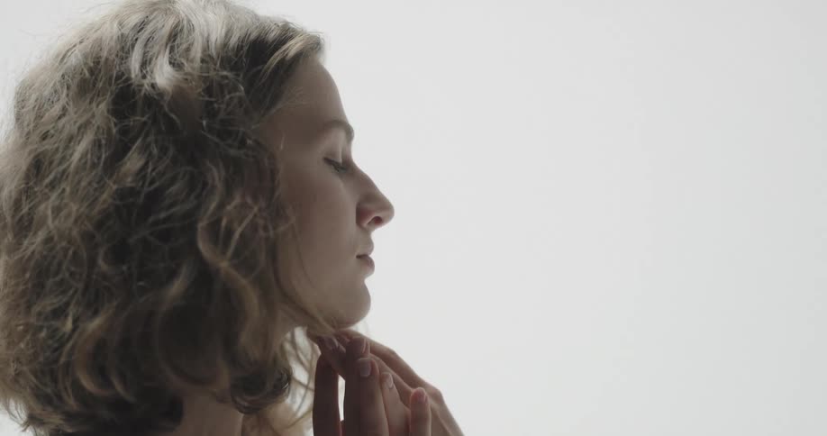 A woman touches her hair