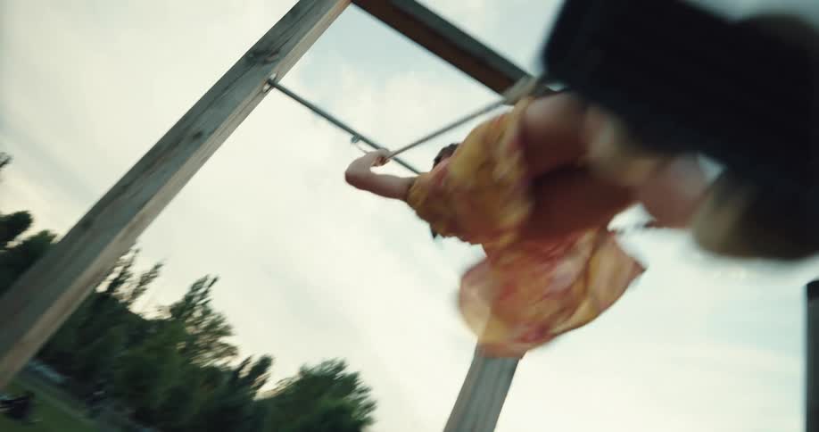 A girl is swinging in the park