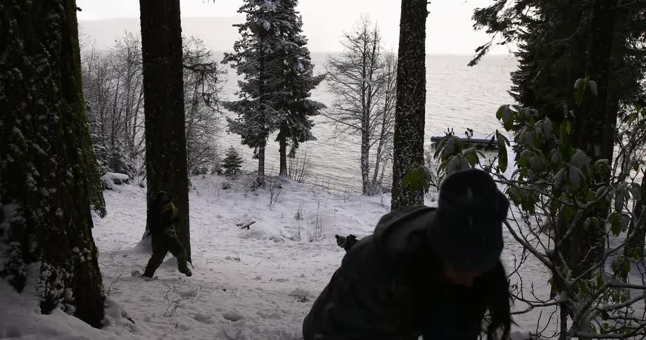 Friends having snowball fight on a hill