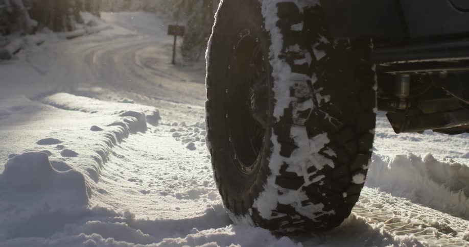 Snowmobile drives off as truck tire pulls up