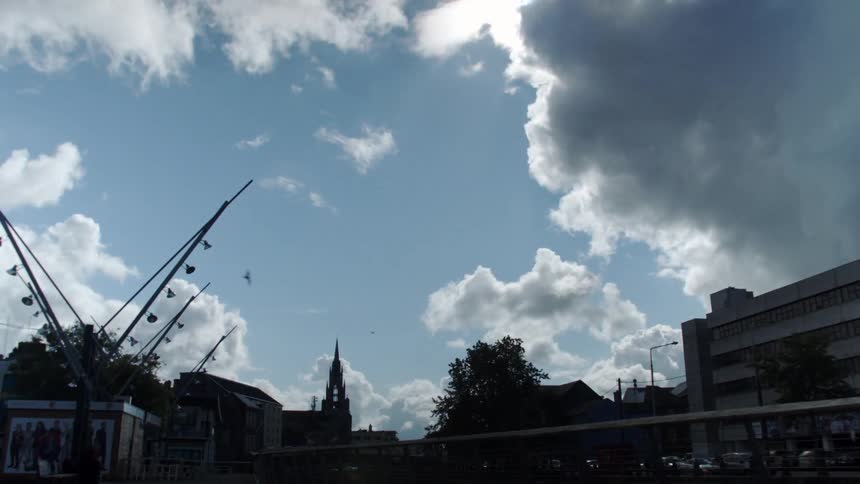 Clouds move over an urban scene during the day