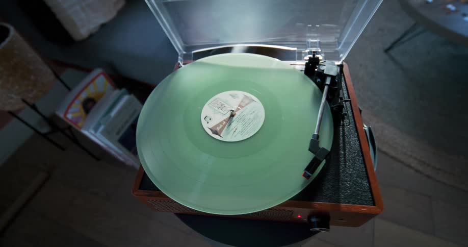 A vinyl album spins on a record player at home
