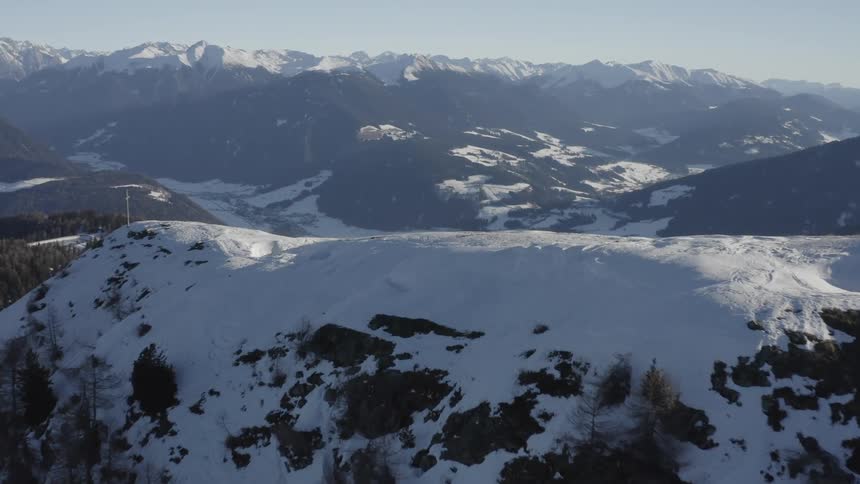 A snow covered mountain ridge reveals a ski slope
