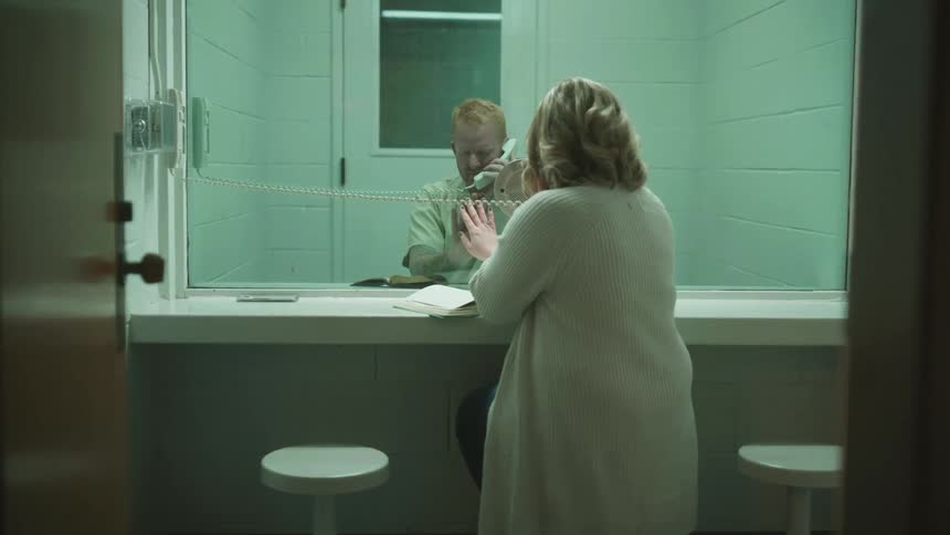 A woman is visiting a prisoner