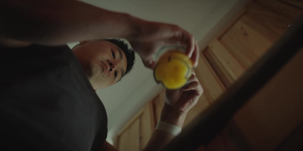 A man mixes raw egg in a glass and drinks it