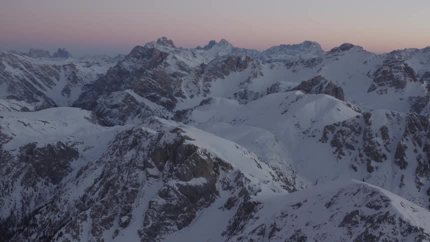 Deep snow covers the peaks of a mountain range
