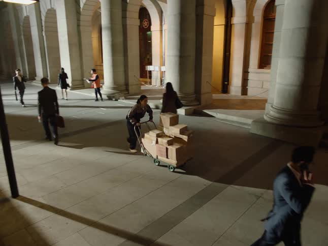 A person is delivering packages to the building