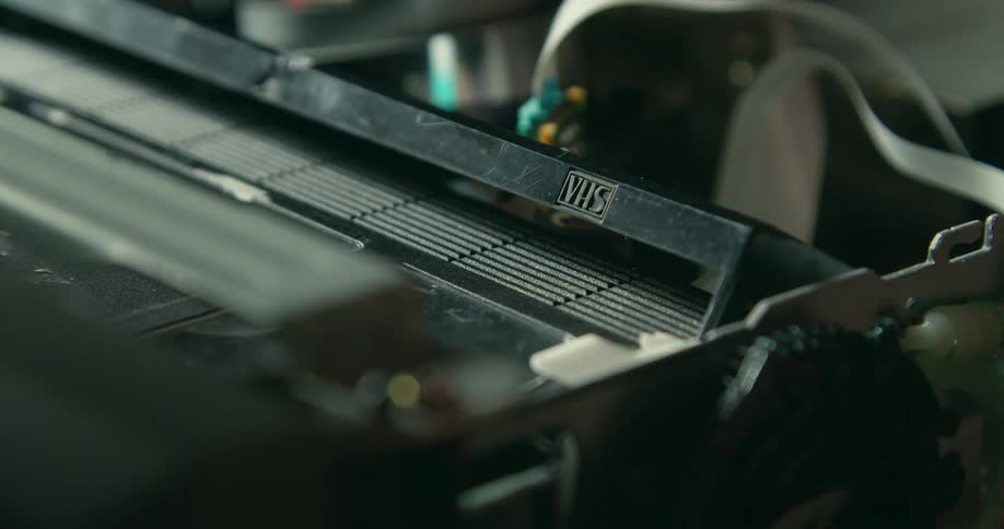 The vhs tape is loaded into the machine