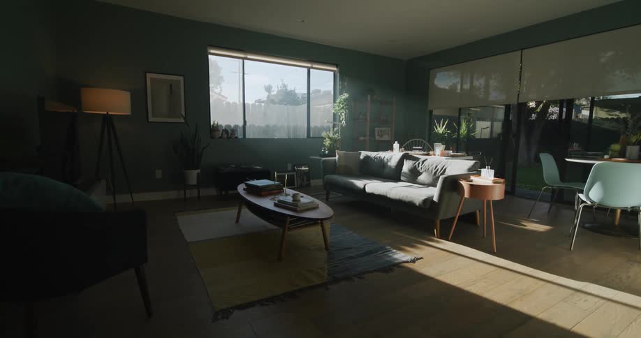A living room is displayed while the sun is shining through window