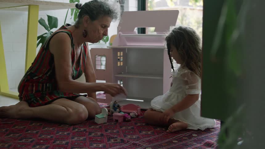 A grandmother is playing with her grandaughter