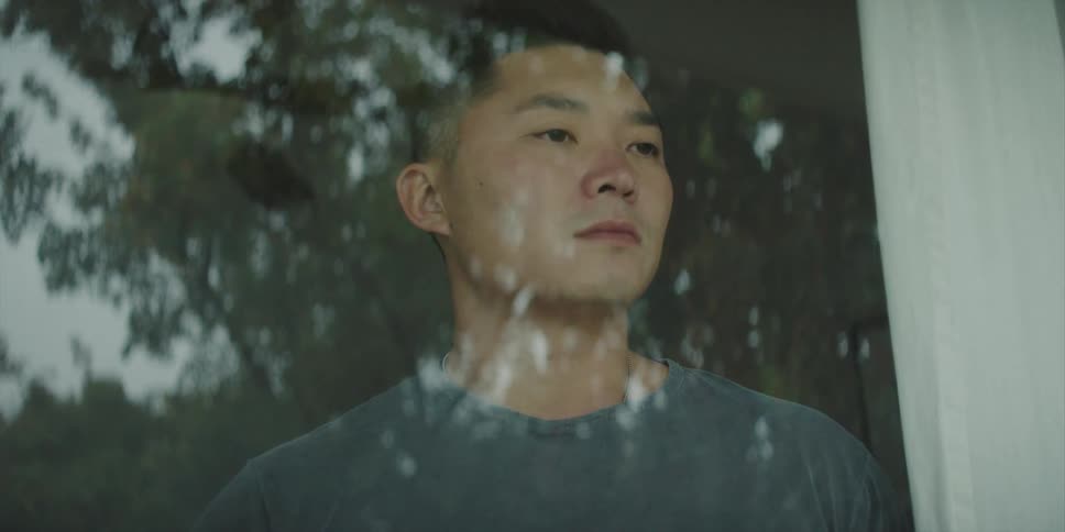 A man is looking out of his window