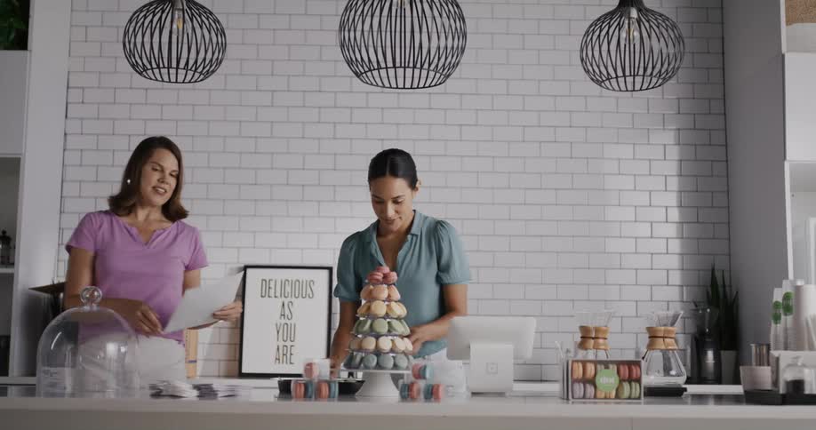 Two women set up displays in the restaurant