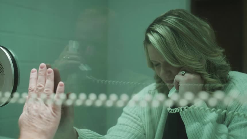 A woman is visiting someone in jail