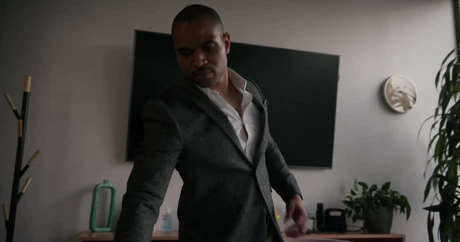 Business man removes laptop from bag and sits down to work