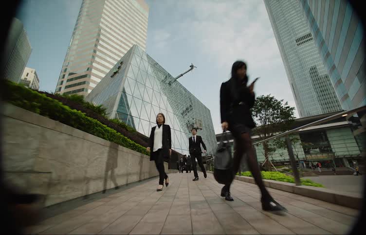 Pedestrians are walking through a downtown city during spring time