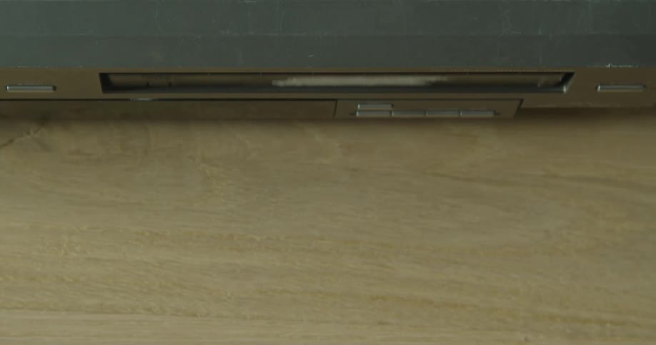 A person is removing a video tape from a machine