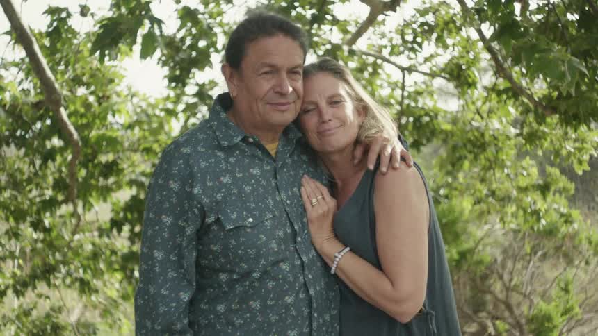 Portrait of a husband and wife standing outdoors in nature together
