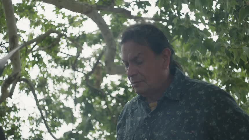 A man is grilling outdoors during the spring time