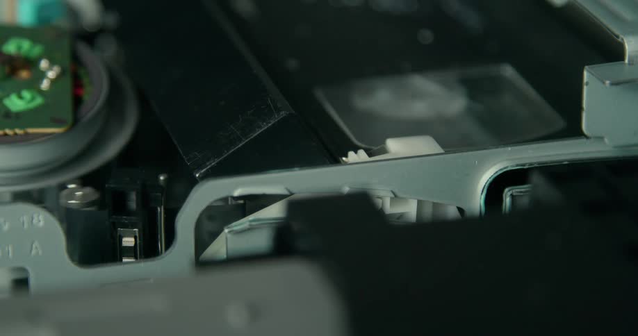 The vhs cassette is playing in the machine