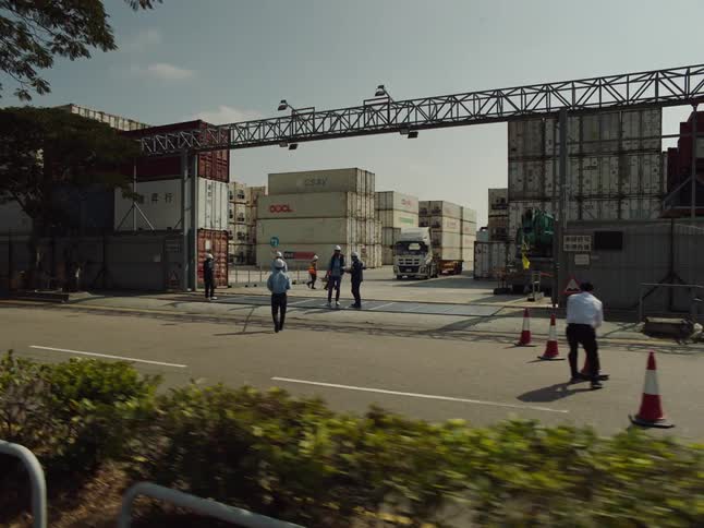 Workers place traffic cones in the street by the port