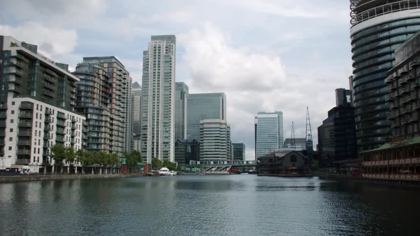 Tall city buildings surround a body of water