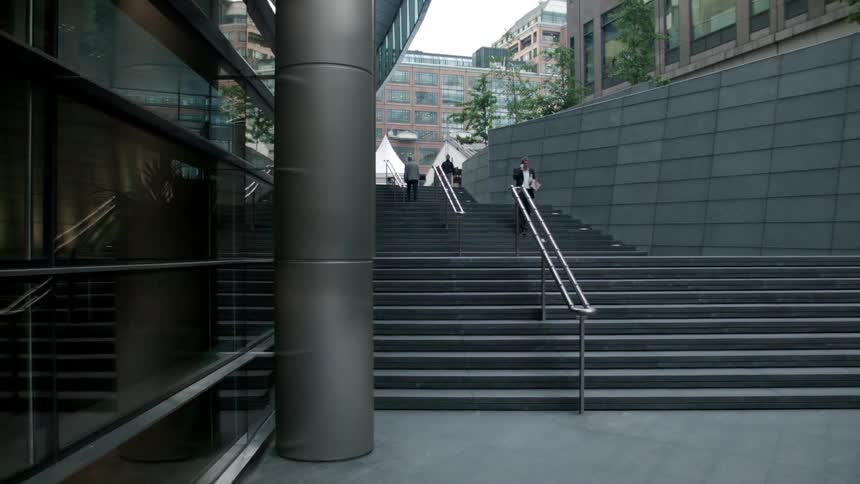 People walk up and down steps near buildings