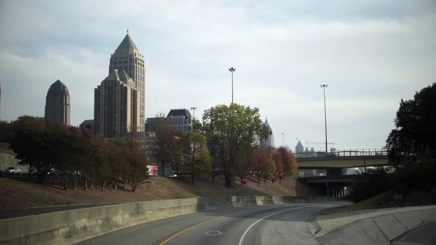 Moving down roads towards a city on a cloudy day