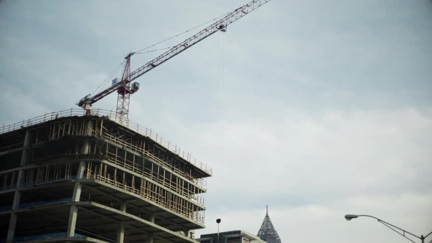 A large crane sits on a building