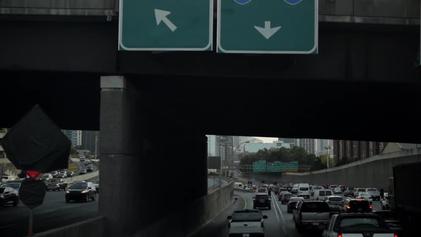 Traffic backed up on a freeway going into and out of a major city