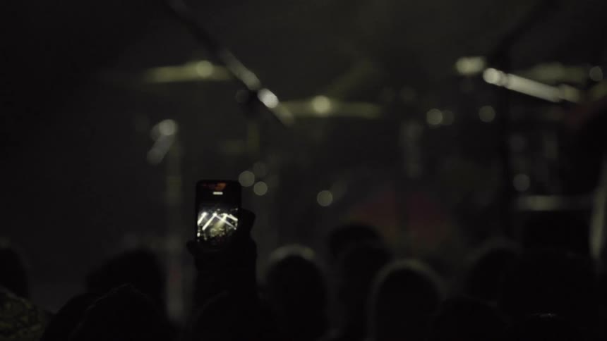 A band performs on stage in front of a crowd