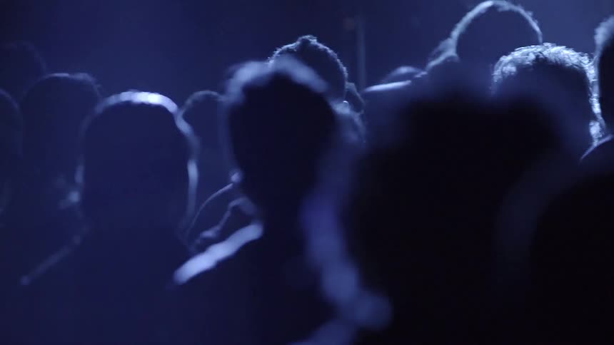A group of people in a dim room