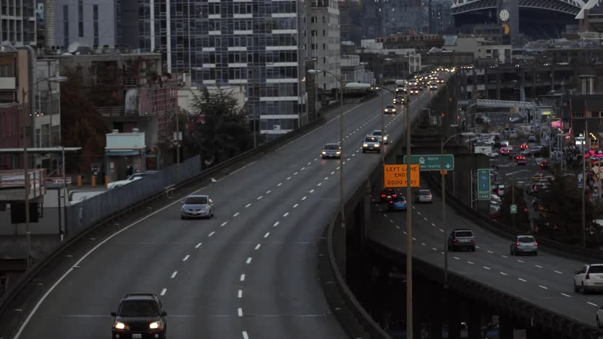 Cars travel on a road running through a city