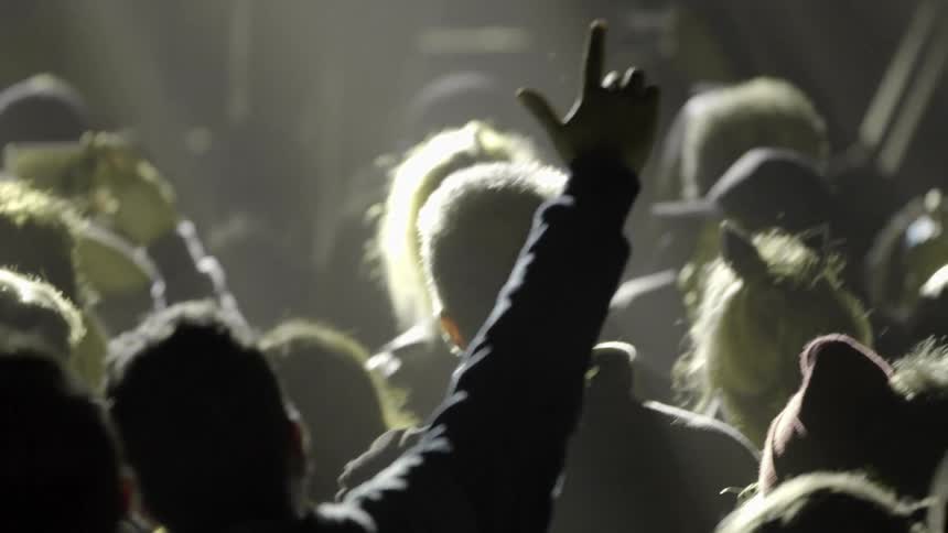 A crowd is watching the stage ahead