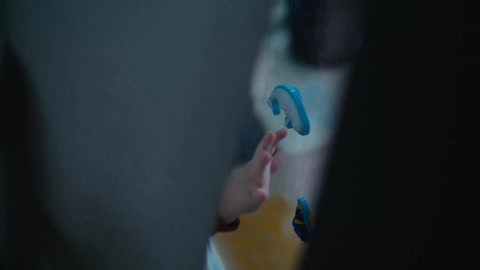 Blonde toddler boy plays with toys on window