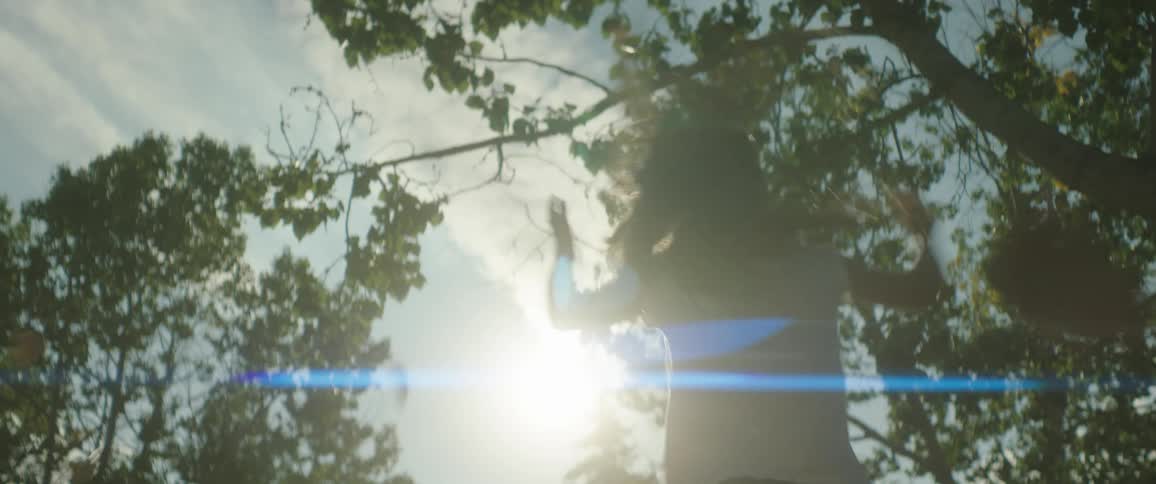A girl throws leaves up in the air