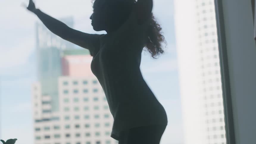 A woman is dancing in a living room