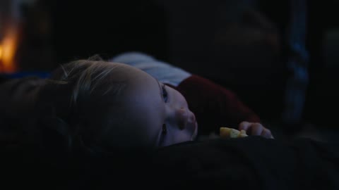 A child rolls off his dads chest