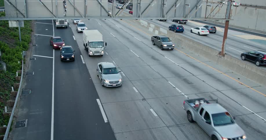 Traffic travels along a freeway during the day