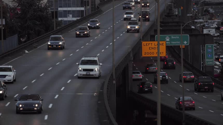 Cars fill two roads by a city