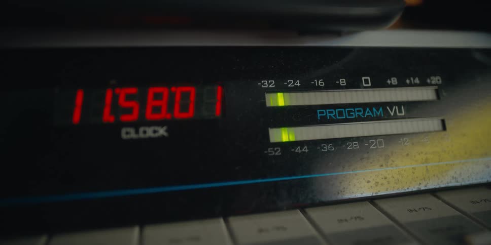 Vu meter indicator lights move back and forth as seconds tick on attached clocks digital display