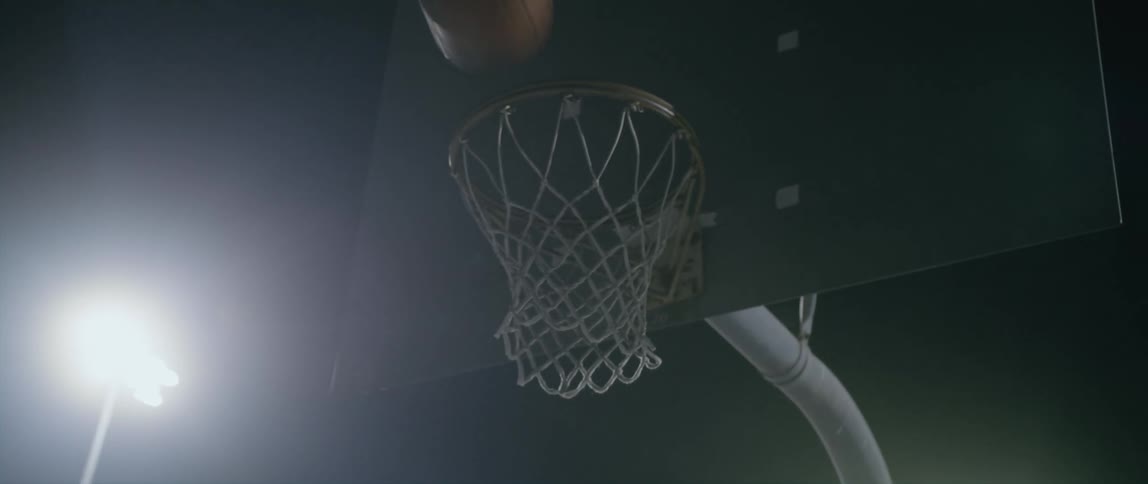 At night basketball passes through hope without touching back board