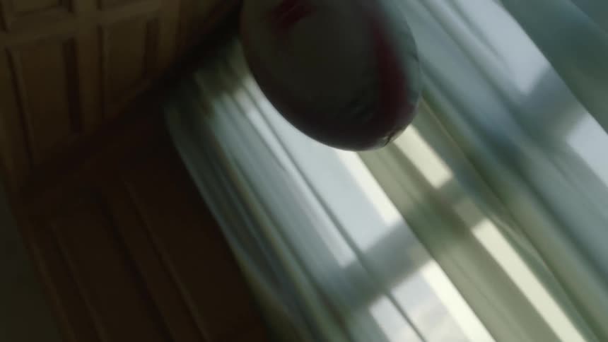 A boy throws a football in the room