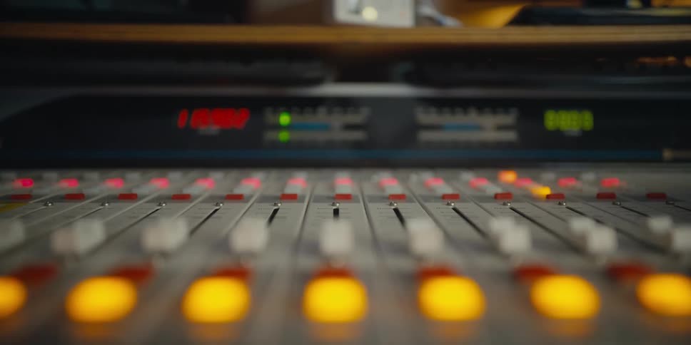 A view of an audio mixing board