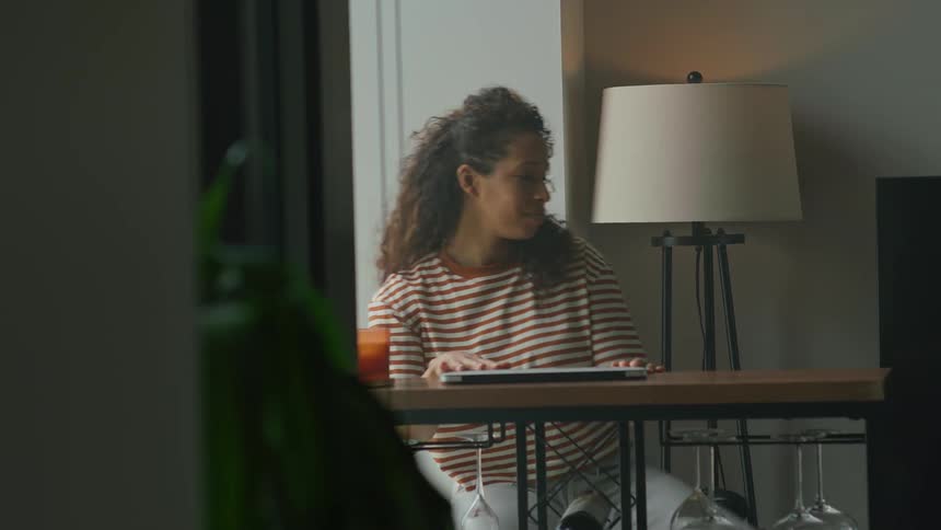 A woman finishes what shes typing then closes her laptop and walks away