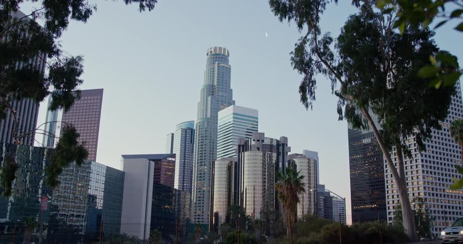 A car drives by with the city as a background