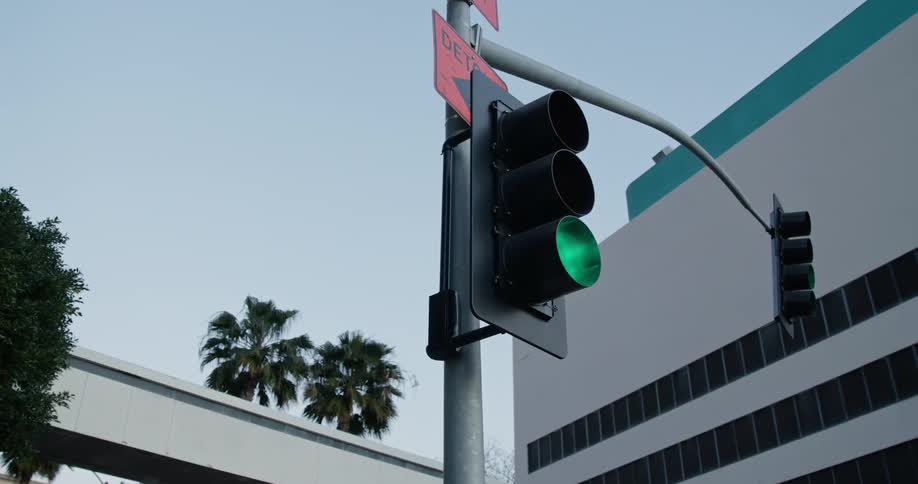Close up view of a street light is displayed in a city