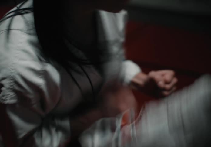 Two people are fighting in a martial arts match