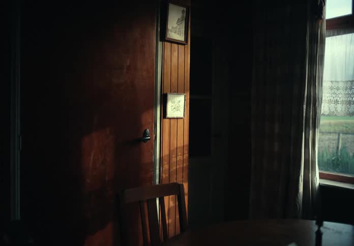 An room in a house is displayed at dusk